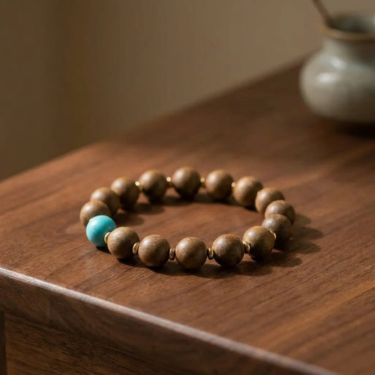 Osmanthus Air He-Xiang bead bracelet on premium walnut tabletop