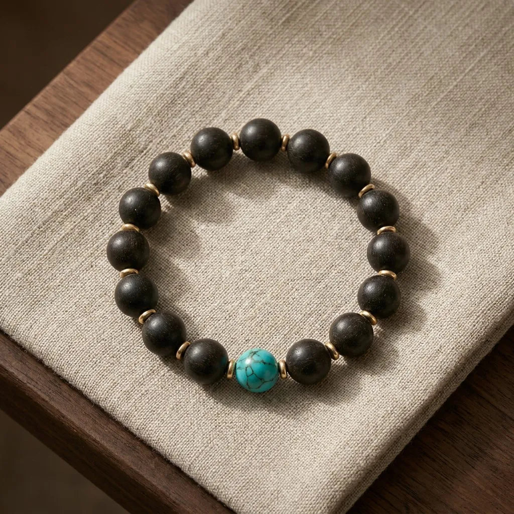 Violet Ease bracelet top view - dark agarwood beads with central turquoise