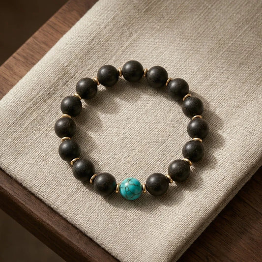 Violet Ease bracelet top view - dark agarwood beads with central turquoise