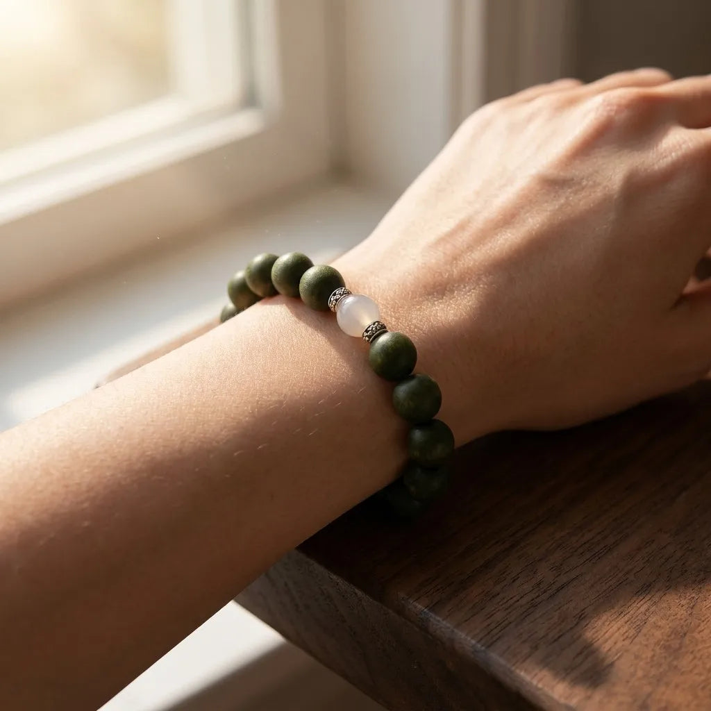 Day Reset bracelet worn on wrist in warm morning sunlight