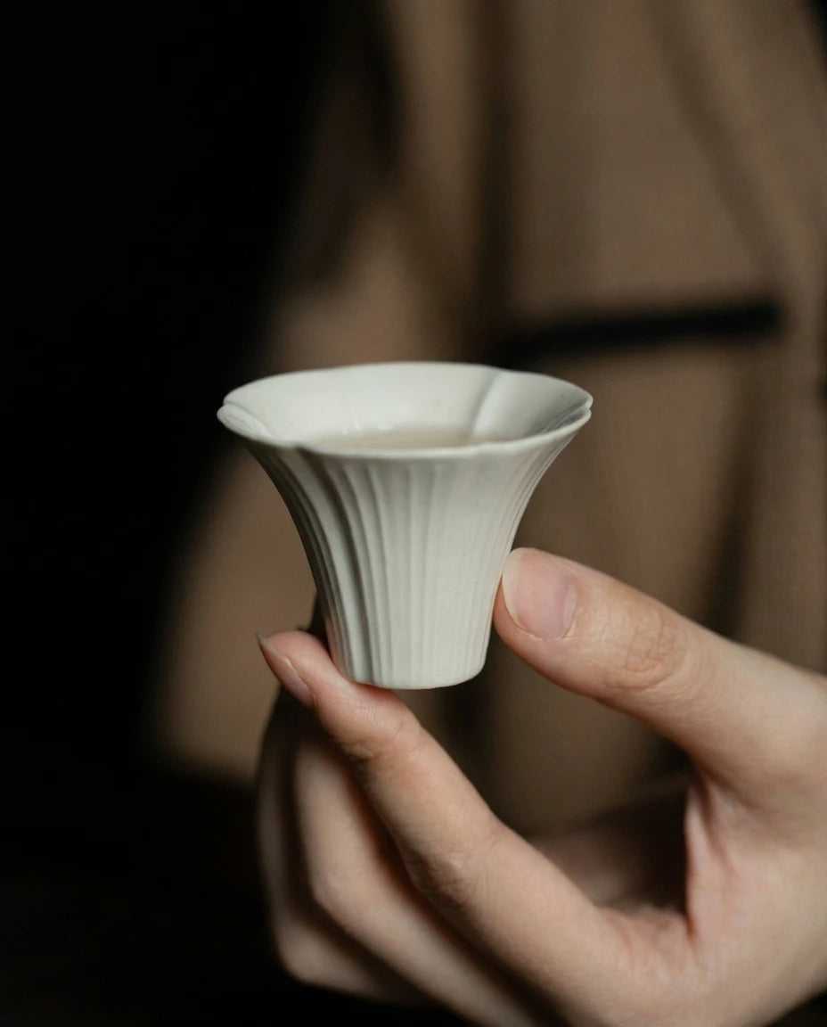 Ash Glaze Sunflower Tea Cup: Hand-held view showing the delicate sunflower petal shape