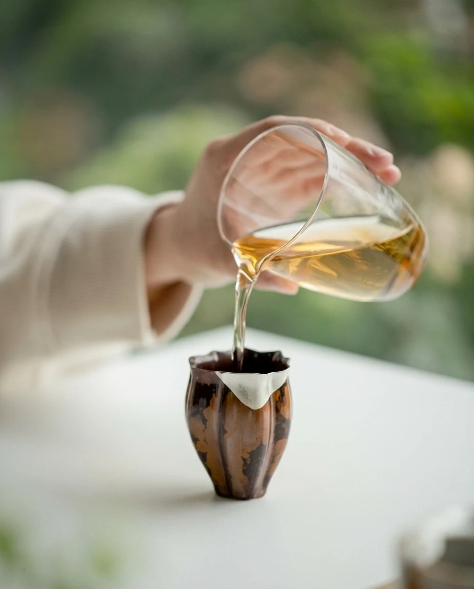 Crescent Moon Tea Cup: Elegant pouring ritual showing the silver-lined rim