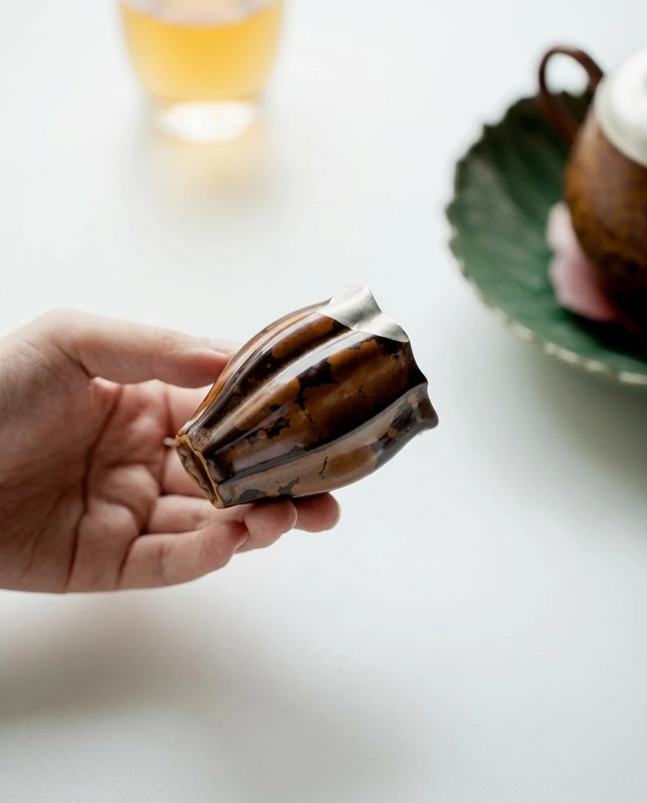 Crescent Moon Tea Cup: Close-up of the chestnut glaze and textured body