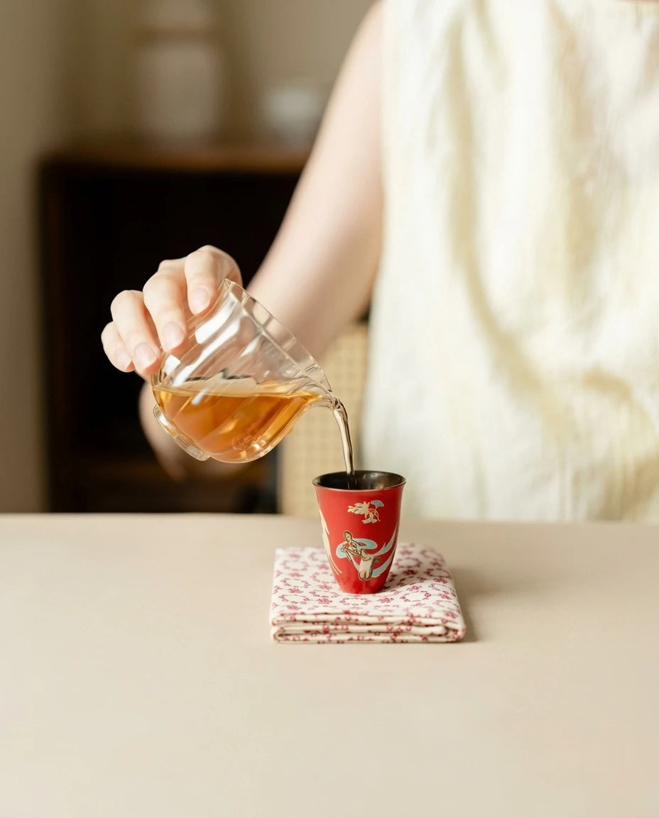 Lifestyle: Clear tea being poured into a red Dunhuang ceramic cup