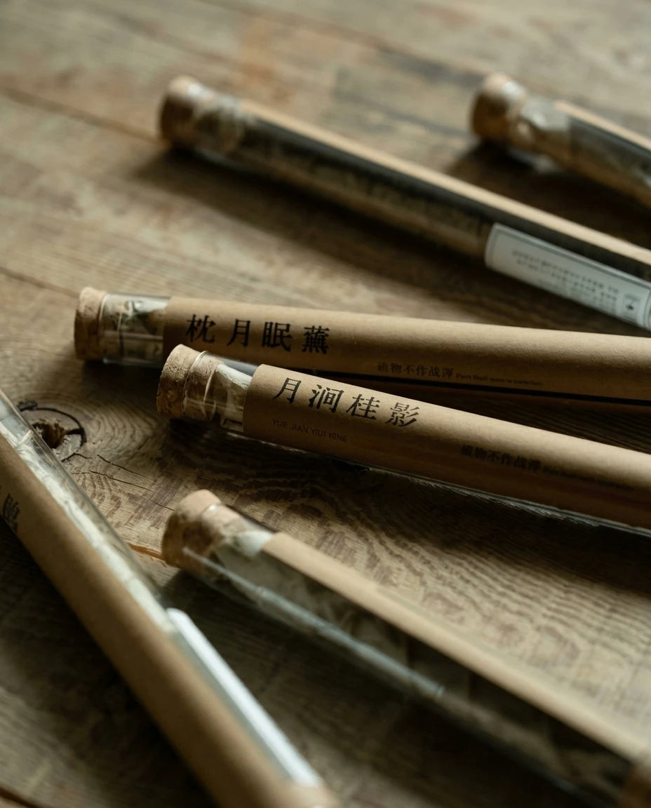 Seven Realms Incense Ritual Set: Detailed close-up of botanical incense tubes on wood