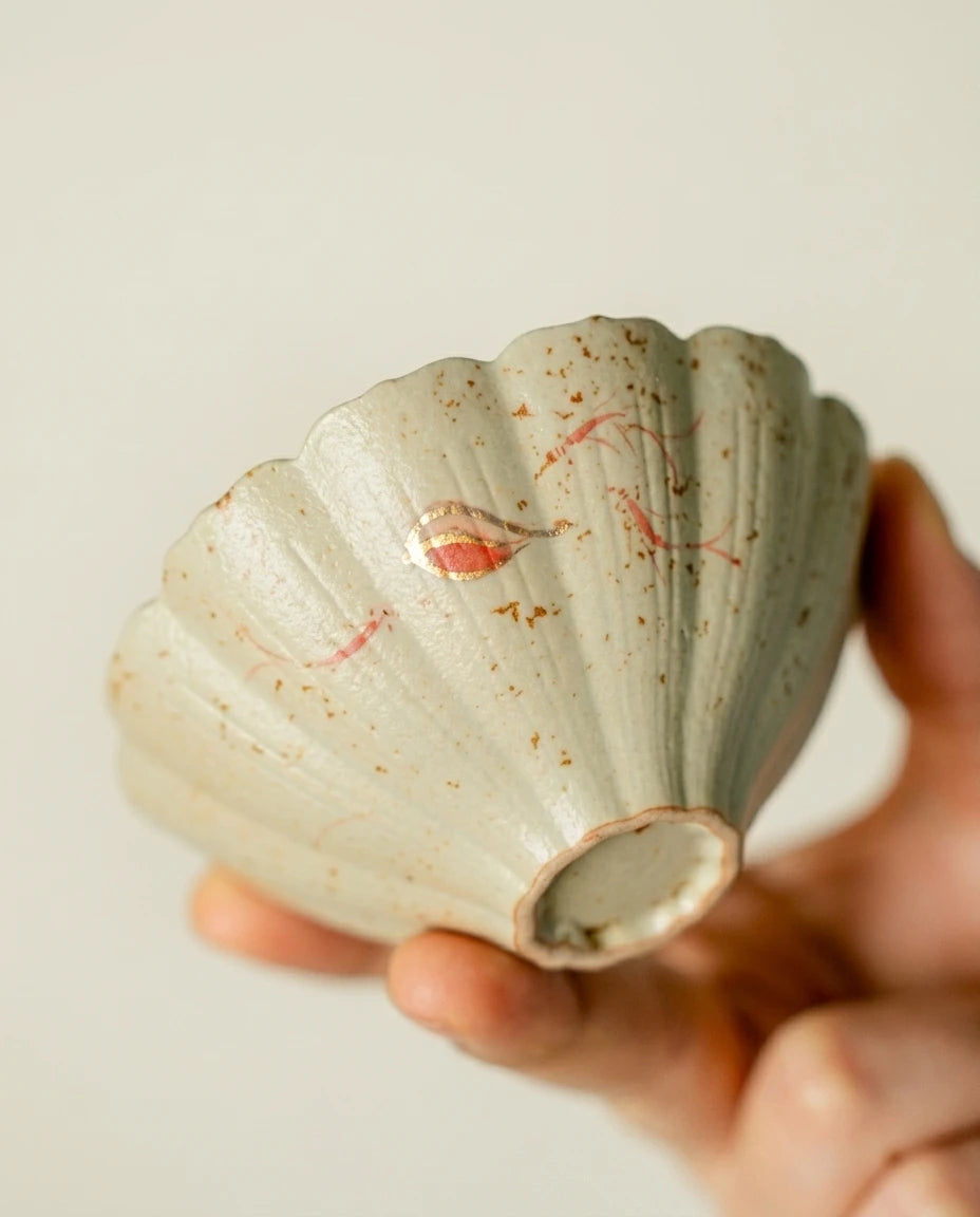 Red Koi Lotus Tea Cup: Side view showing the petal-shaped rim and textured glaze