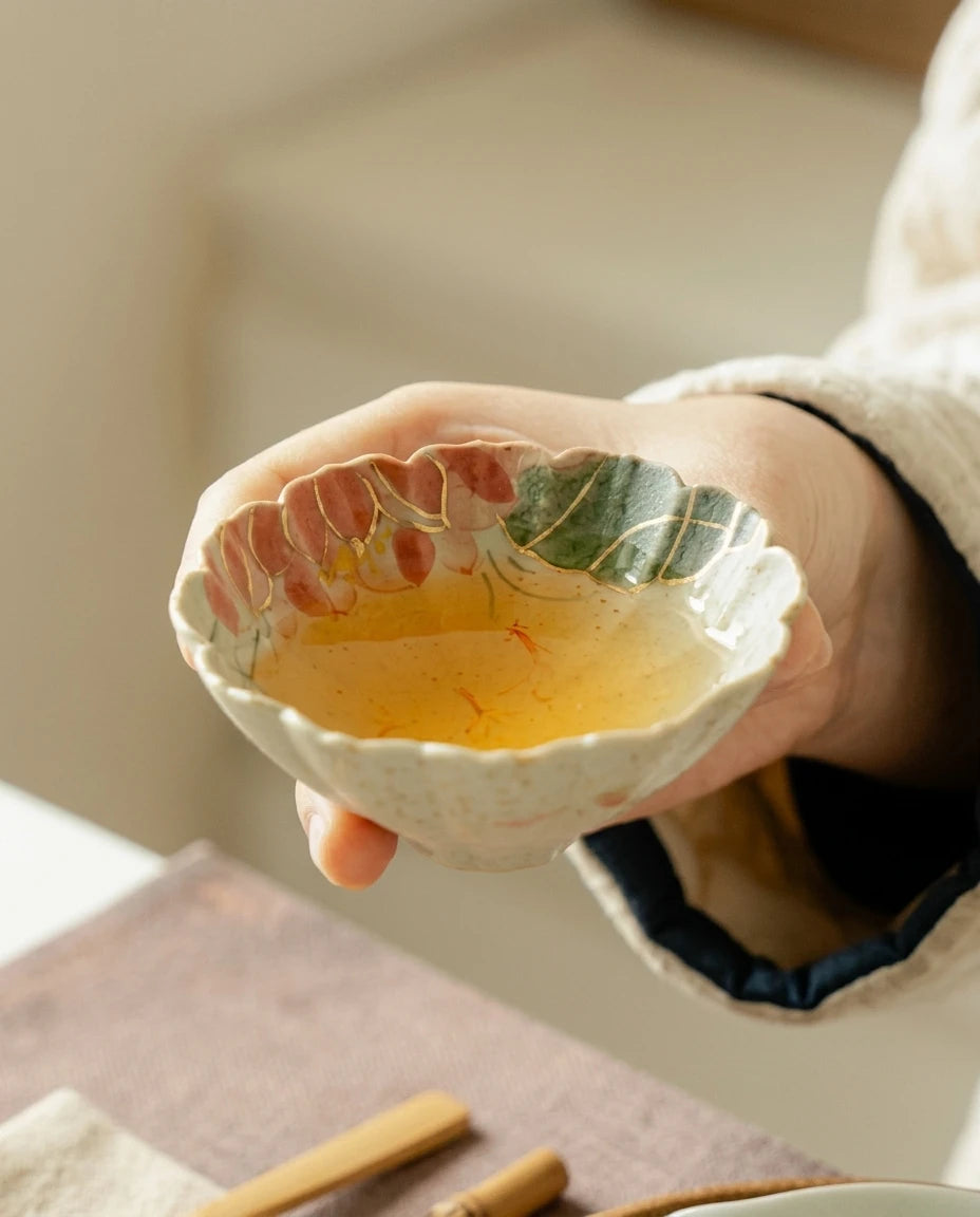 Red Koi Lotus Tea Cup: Lifestyle shot showing tea being served in the cup