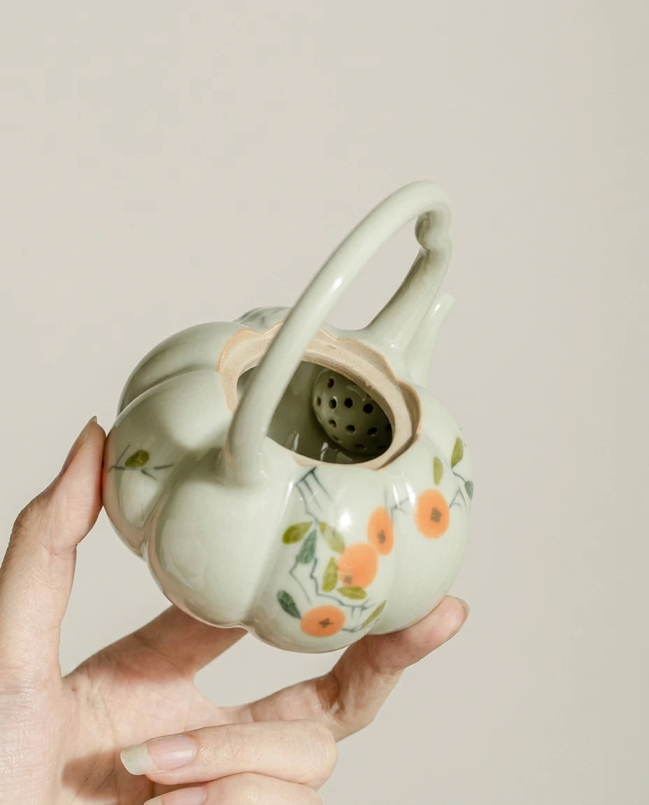 Top view of the wood-ash glaze pumpkin teapot showing the built-in tea strainer