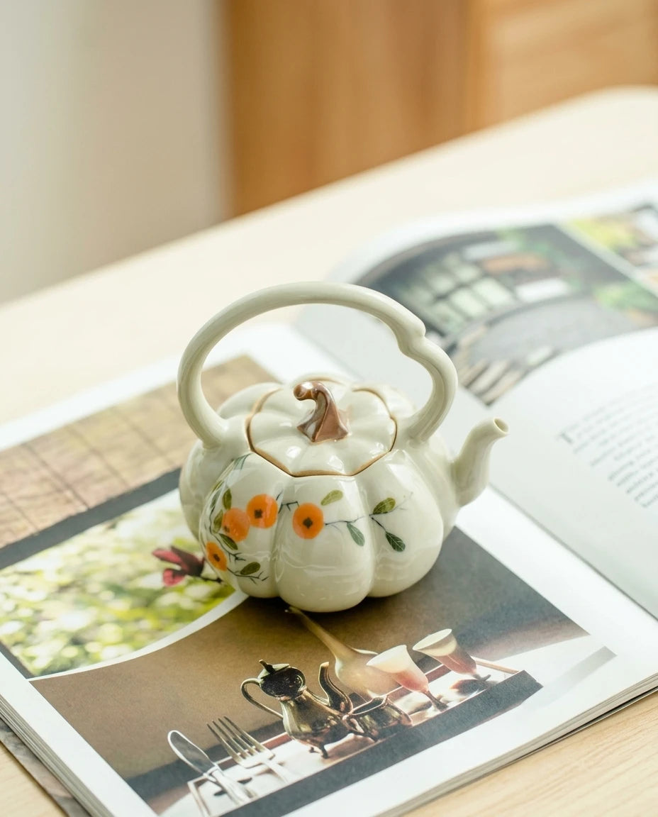 Editorial scene: the pumpkin teapot resting on an open book
